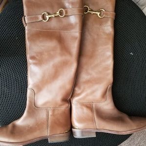 Knee length riding boots.